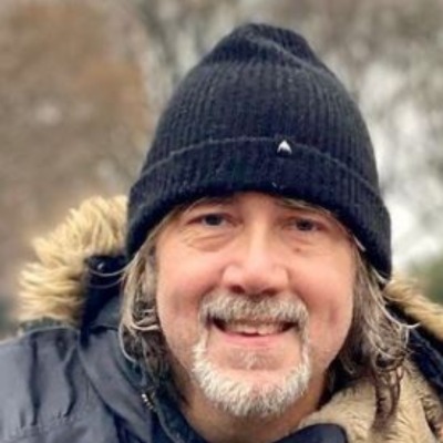 Vincent Mazeau is a beanie and jacket while posing in a cold place.